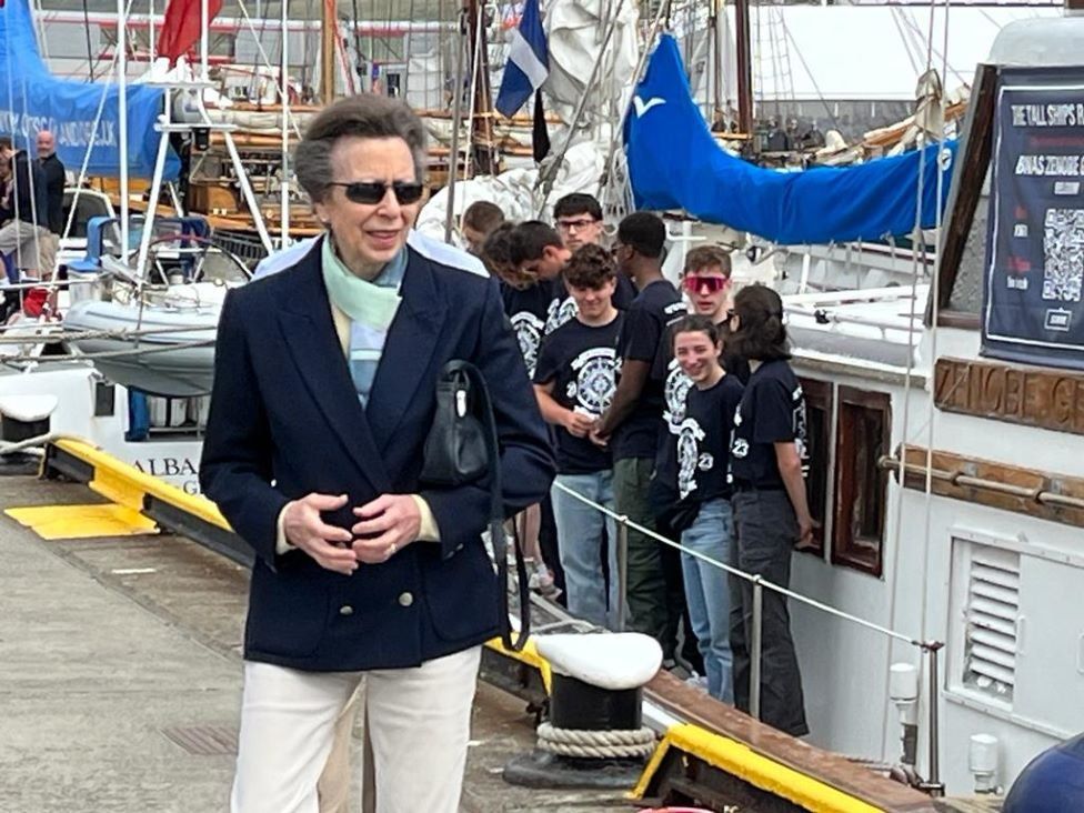 Princess Anne standing beside one of the vessels from the races.