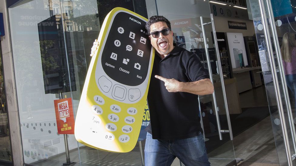 Dom Joly with a giant Nokia 3310
