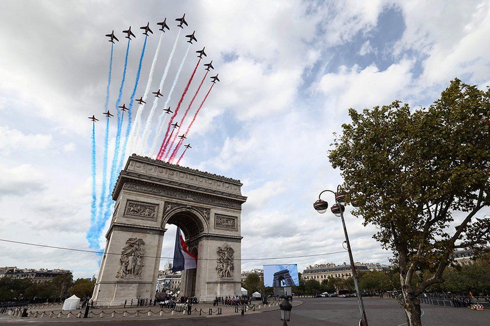 French Air Force elite acrobatic flying team Patrouille de France (PAF) and the Royal Air Force's aerobatic team the Red Arrows perform a fly past