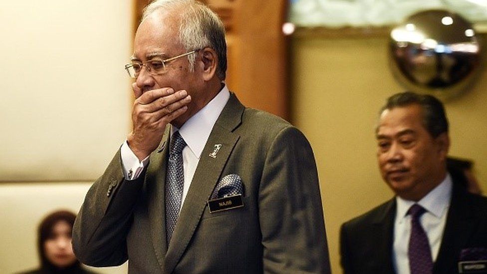 n this picture taken on July 8, 2015 Malaysian Prime Minister Najib Razak (L) gestures as he arrives along with Deputy Prime Minister Muhyiddin Yassin (R) to take part in an event for new government interns at the Prime Minister's office in Putrajaya.