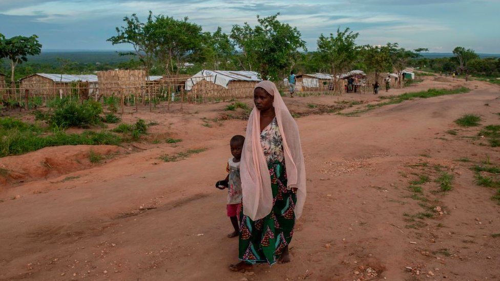 A woman and her child walk in the community of Ntocota, Matuge District in Pemba, Cabo Delgado Province on February 22, 2021