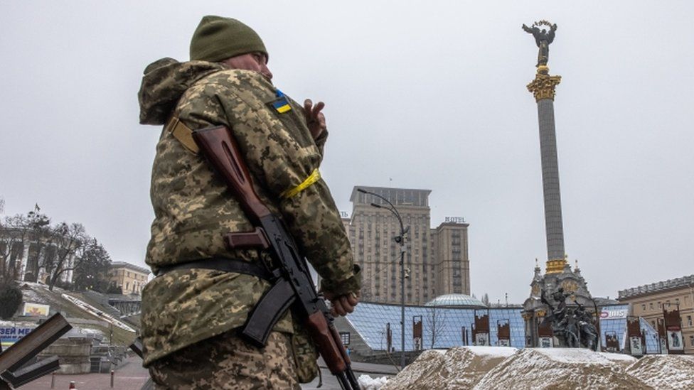 A Ukrainian military member stands guard at Independence Square in Kyiv, 2 March 2022