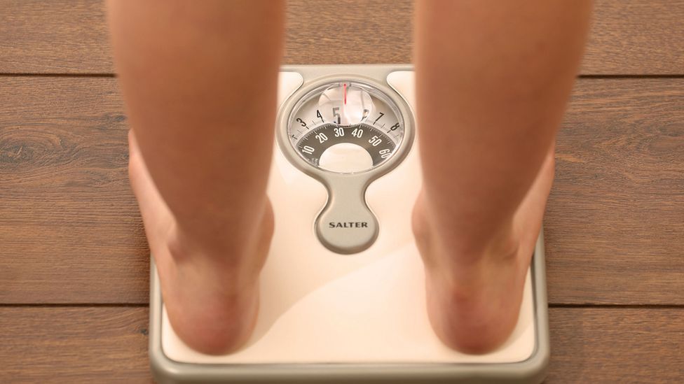 A person standing on a set of scales