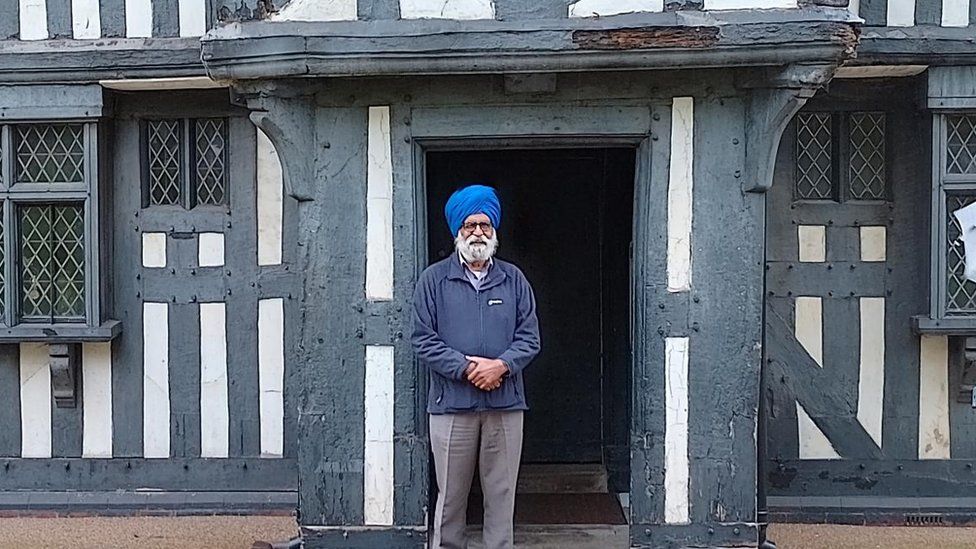 Councillor Charn Singh Padda outside the Oak House Museum.