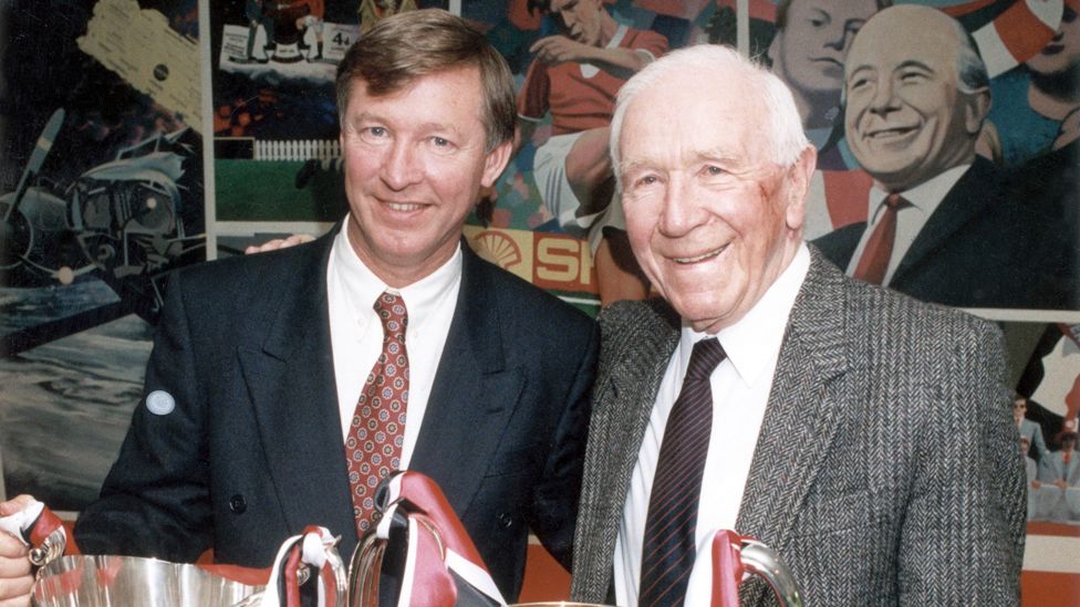 Sir Alex Ferguson and Sir Matt Busby pose together with their respective European trophies in 1991