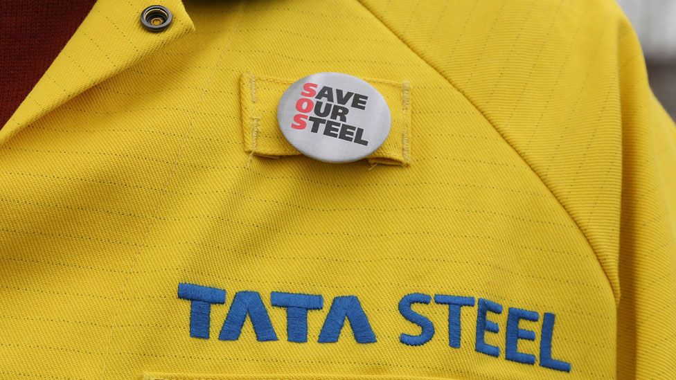 Steel worker wearing a badge saying "Save our steel"