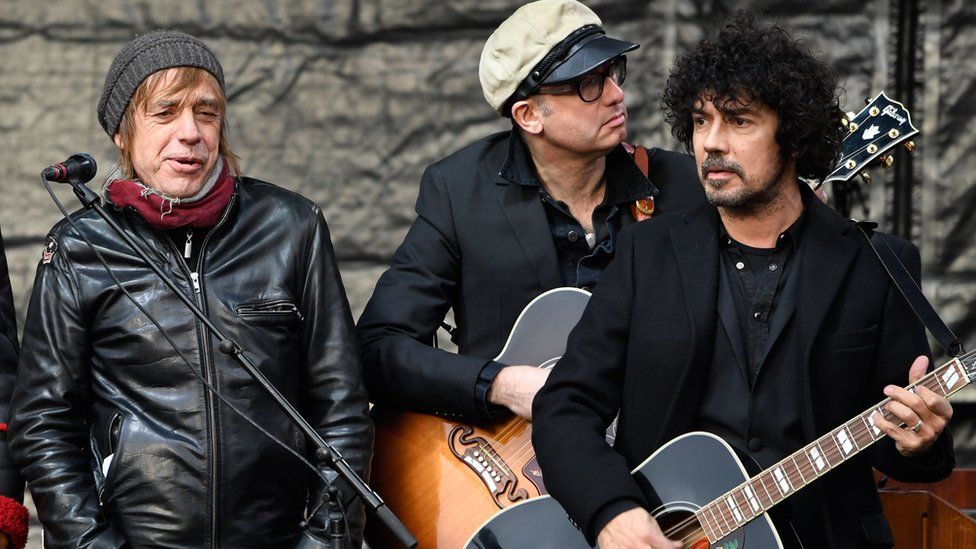 Musicians perform Johnny Hallyday songs outside the Madeleine church in Paris during the funeral ceremony of late French singer, 9 December 2017