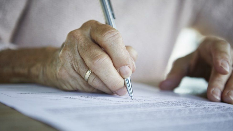 Older person writing a letter