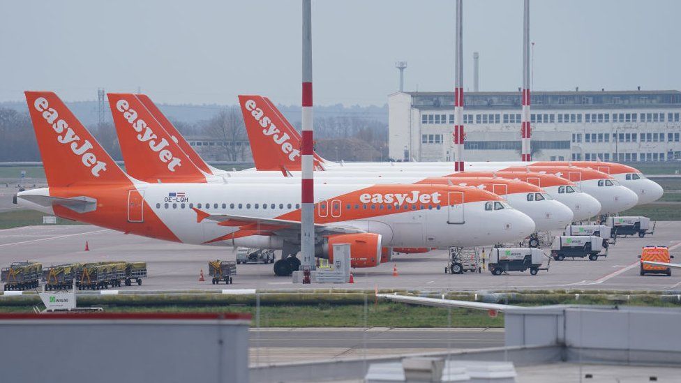 Passenger planes of discount airline EasyJet stand on the tarmac at Berlin-Schoenefeld Airport.