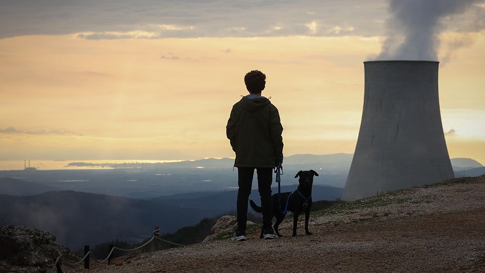 A boy with his dog visits 'Delle Biancane' park of the geothermal power plant of Monterotondo Marittimo in Tuscany on February 13, 2022 in Monterotondo Marittimo - Grosseto, Italy.