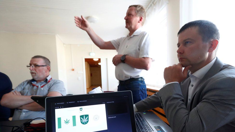 A design for Kanepi municipality"s flag and coat of arms featuring a cannabis leaf is shown on a laptop at the municipality council's vote in Polgaste, Estonia on 15 May 2018