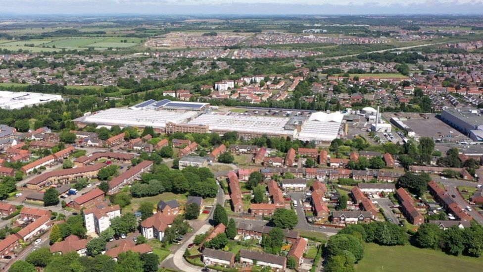 Aerial view of the Nestle factory surrounded by homes