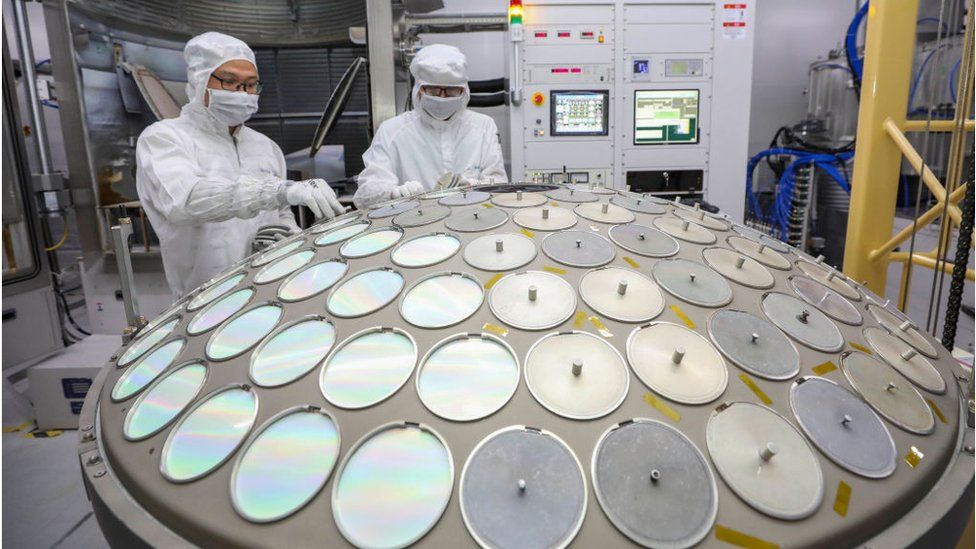 Employees work on the production line of semiconductor wafer at a factory of Jiangsu Azure Corporation Cuoda Group