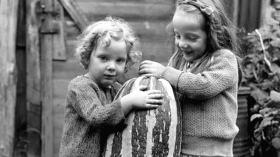 Two young girls with a marrow grown at at allotment in Surrey in 1941