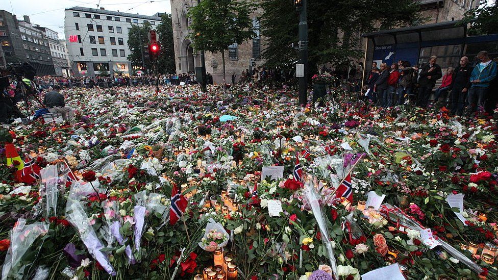OSLO, NORWAY - JULY 25: A sea of flowers and candles are left outside Oslo Cathedral