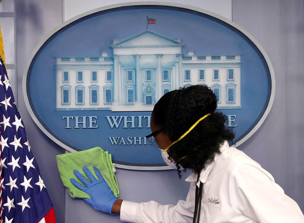 A worker cleans a wall