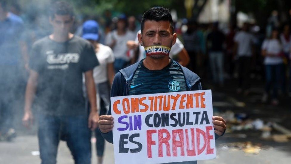 An opposition activist holds a sign reading "Constituent (assembly) Without Referendum is Fraud" as he demonstrates against President Nicolas Maduro"s government in Caracas, on June 5, 2017.