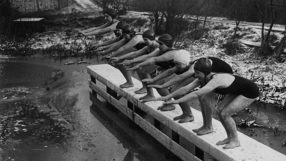 In 1935, regulars of the women's pond at Kenwood on Hampstead Heath, London are undeterred by the cold, prepare to dive into the icy water