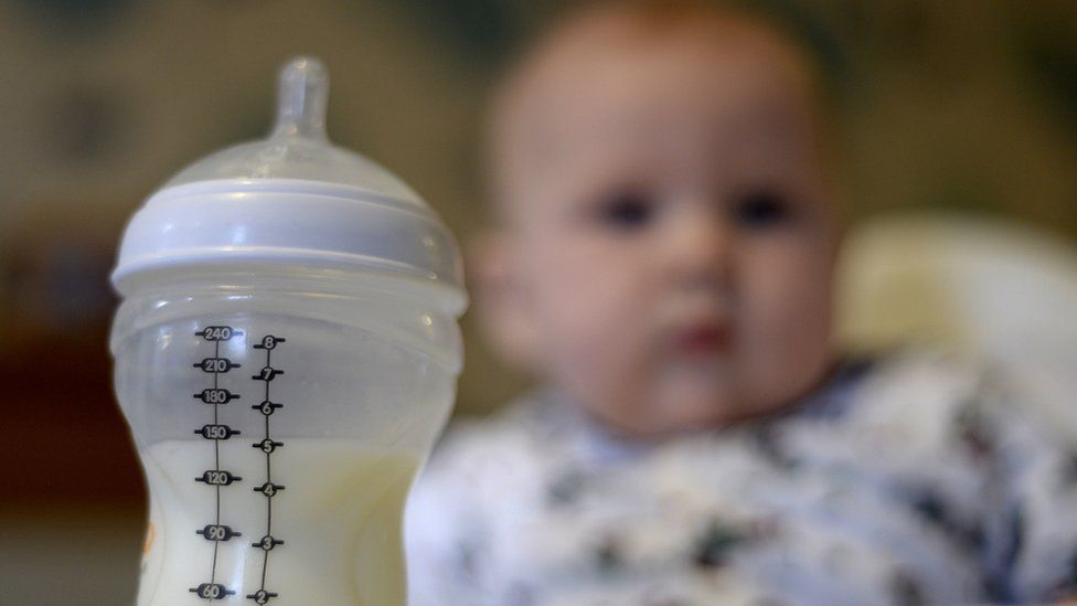 Baby with formula bottle