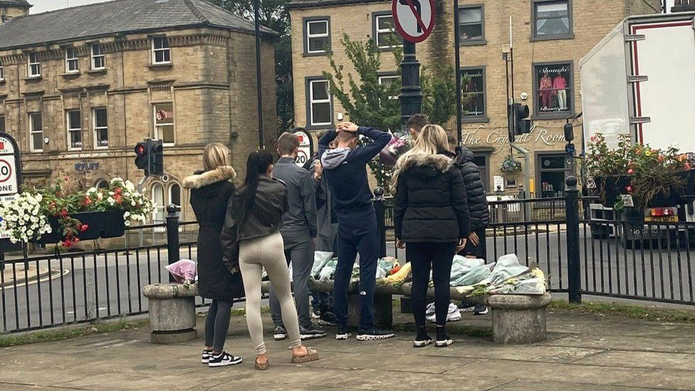 Mourners placing flowers at the scene of the stabbings