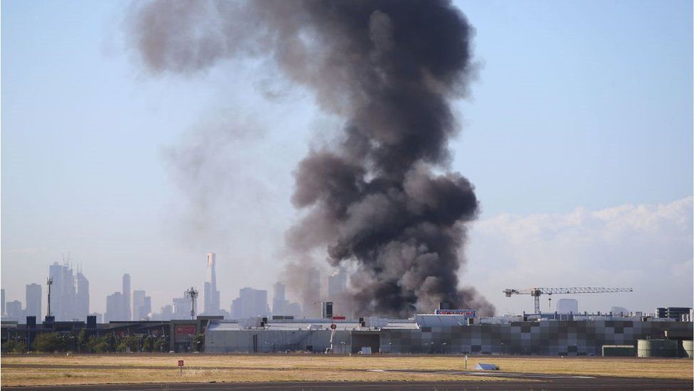 A huge cloud of smoke rises above the shopping centre, viewed from the nearby airport on 21 February 2017, Melbourne, Australia.