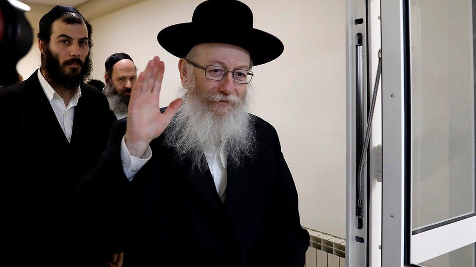 Israeli Health Minister Yakov Litzman waves to journalists after handing in his resignation during the weekly cabinet meeting in Jerusalem November 26, 2017.