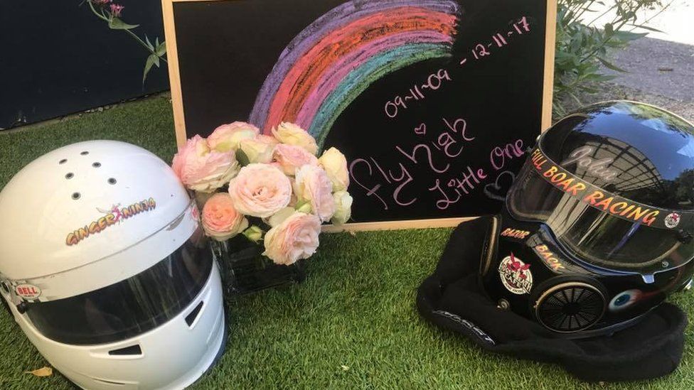 Helmets and flowers form a tribute to Anita Board