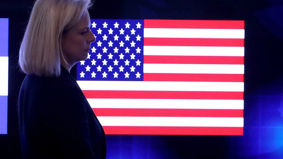 Nielsen in front of a US flag