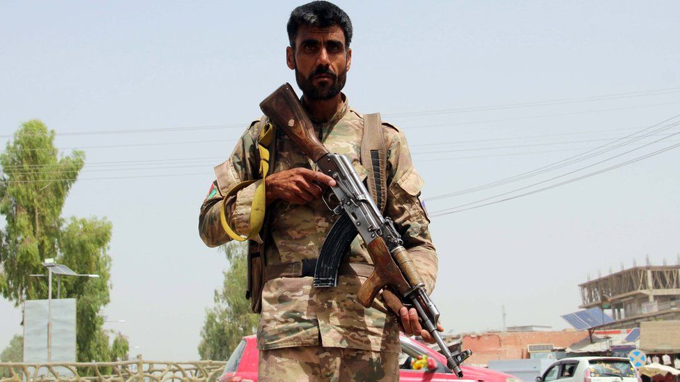 An Afghan security official stands guard at a check point in Lashkar Gah, the provincial capital of Helmand province, Afghanistan, 11 July 2021.