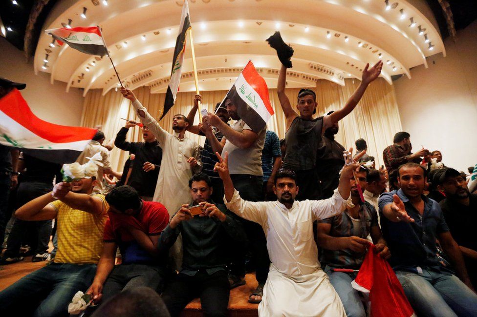 Followers of Moqtada al-Sadr are seen in the parliament building 30 April