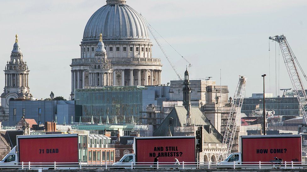 The three vans with the billboards passing over a bridge near St Paul's Cathedral