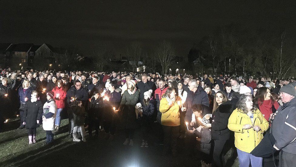 People gather on the village green