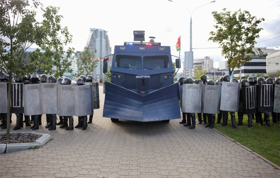Belarusian riot police with snow-plough-like crowd control vehicle