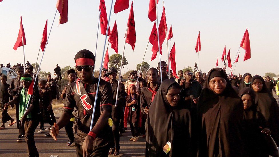 Shia Muslims march on the highway during a symbolic procession commemorating the 40th anniversary of the Ashura religious ceremony on 2 November 2015 in the village of Dakasoye, northern Nigeria