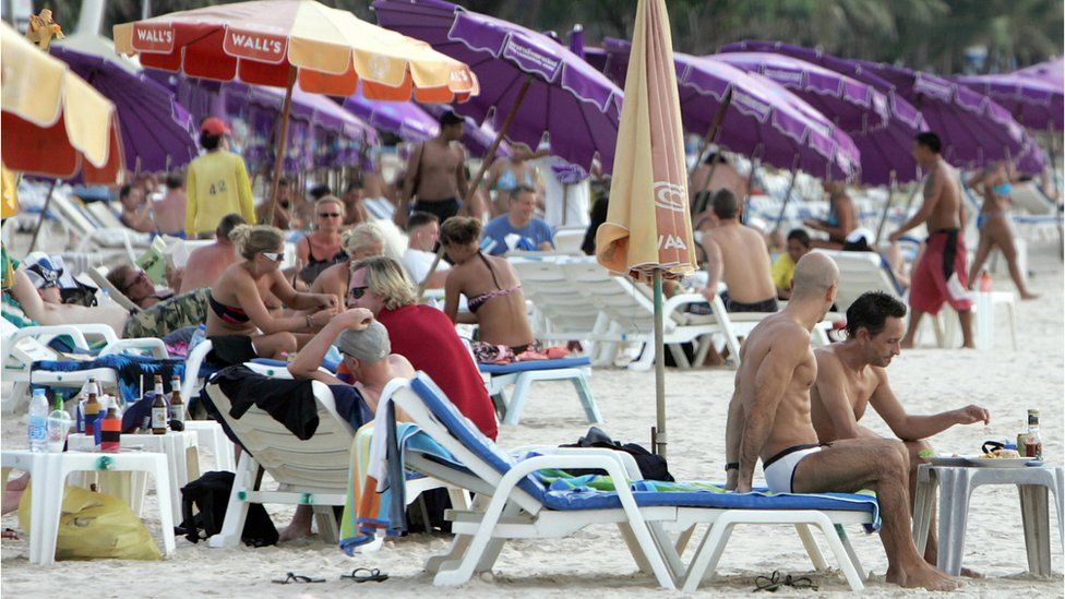 Tourists at the popular Patong beach in Phuket, where a smoking ban is being introduced, 2 December 2006