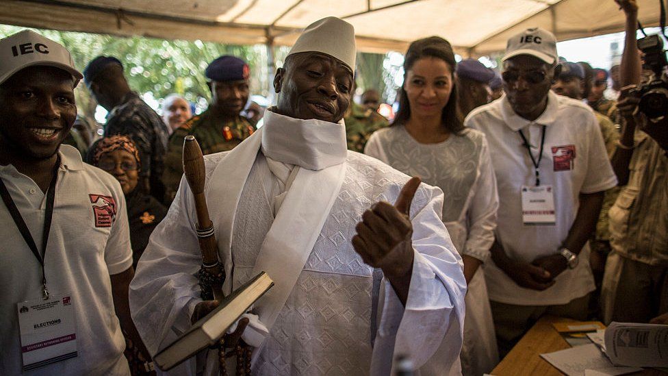 Yahya Jammeh showing his ink-printed thumb as evidence he voted