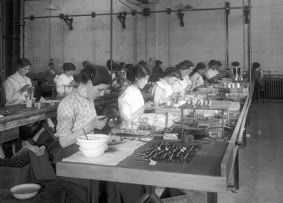 Workers assembling parts on the production line at Marconi Wireless Telegraph Works in Essex, UK in 1916