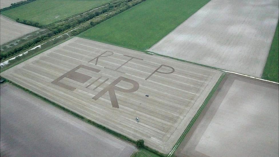 Aerial photo of the Queen's monogram ploughed into a field