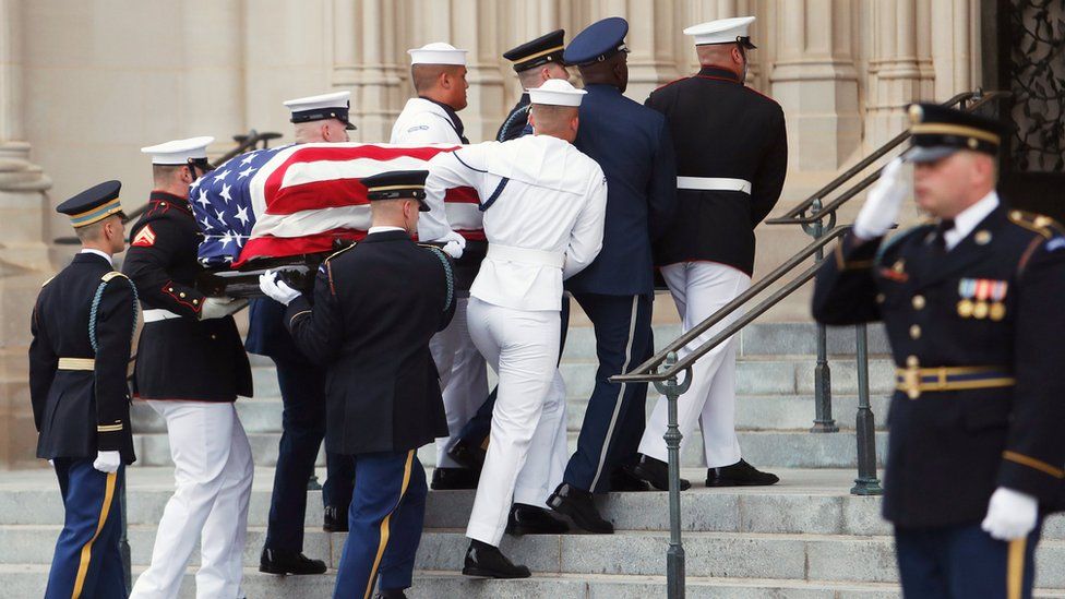 An honour guard carries the coffin of the late Senator John McCain into the Washington National Cathedral, September 1, 2018