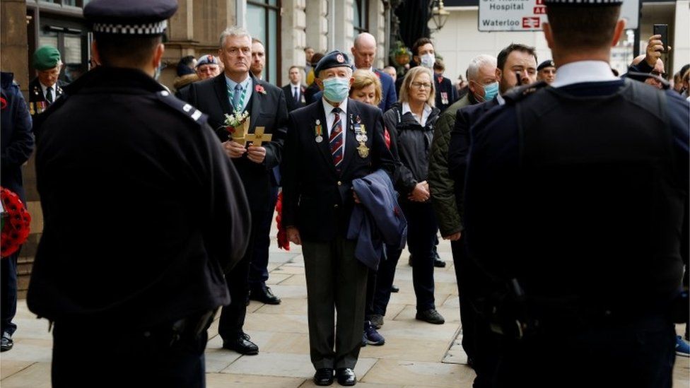 Members of the public and veterans observe two minute"s of silence, away from the Cenotaph