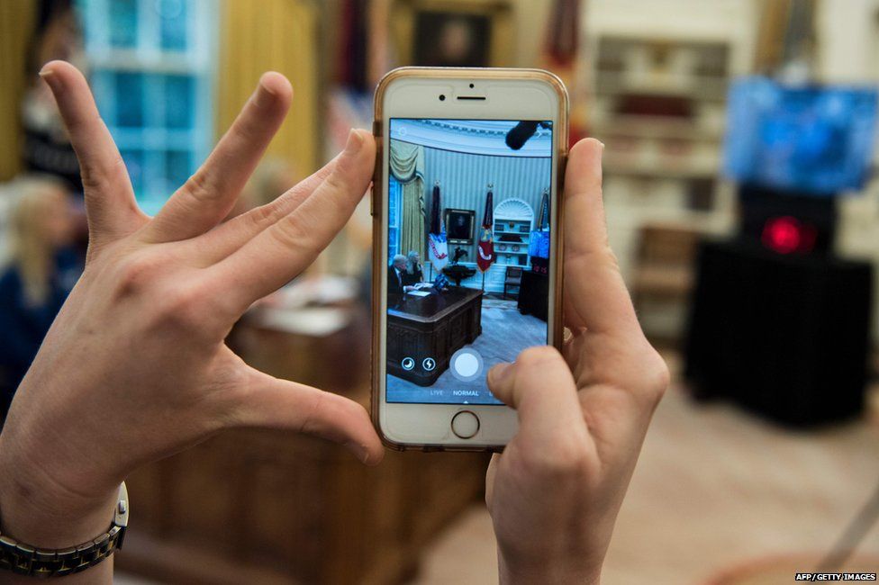 A White House staff member recording the conversation on their phone