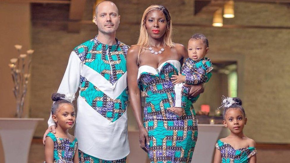 Justin and Aminat McClure pose in traditional Nigerian dress with their twin daughters and son