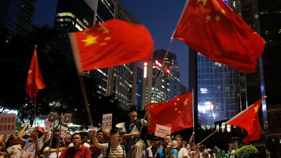 Pro-Beijing protesters wave Chinese flags in Hong Kong
