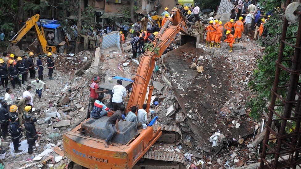 Rescuers with excavator at the scene in Mumbai