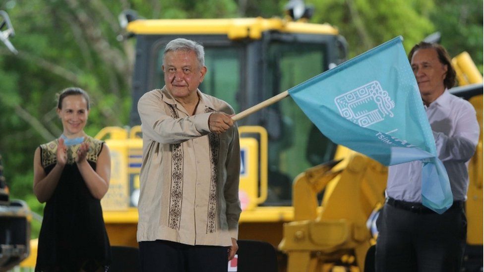 The President of Mexico, Andres Manuel Lopez Obrador (C), waves a flag during an event to mark the start of work on the fourth section, Izamal-Cancun, of the Mayan Train, in Lazaro Cardenas, Quintana Roo, Mexico, 01 June 2020.