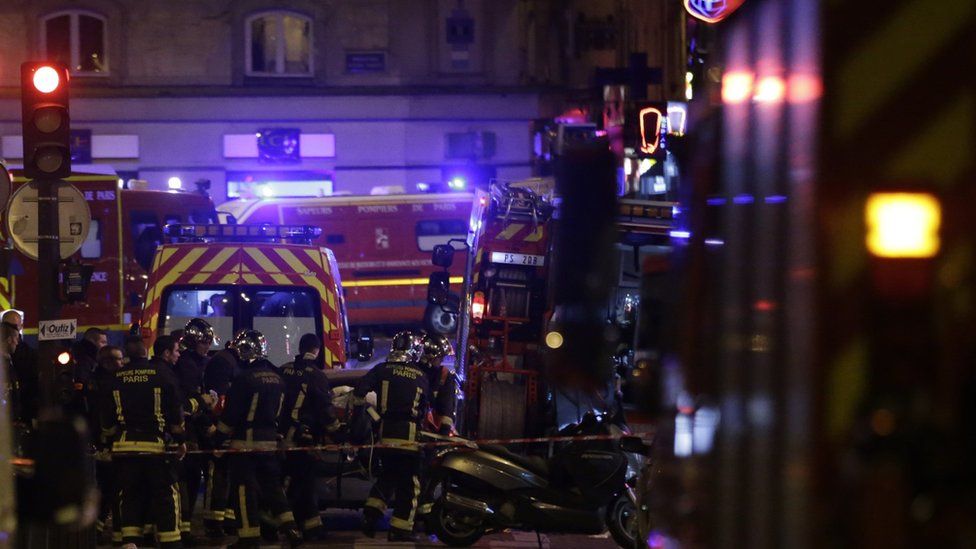 Rescuers move a victim of an attack in the French capital Paris, on November 13, 2015.