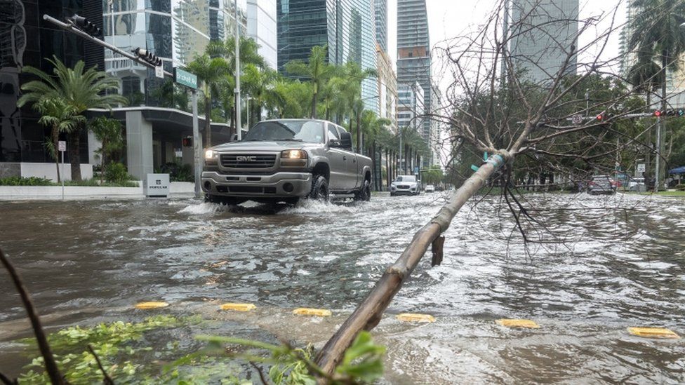 Parts of Miami's city centre were flooded and trees downed by torrential rain