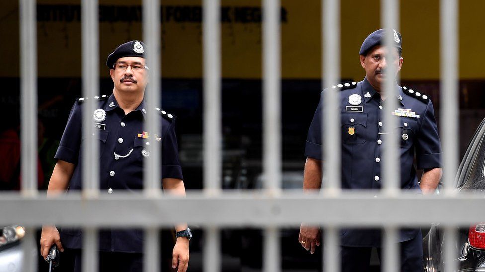 Senior Malaysian police personnel walk outside the Forensic wing at the Hospital Kuala Lumpur on February 15, 2017