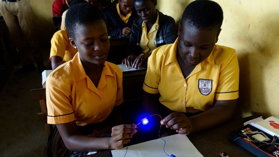 Princess Makafui and her friend use the science kit
