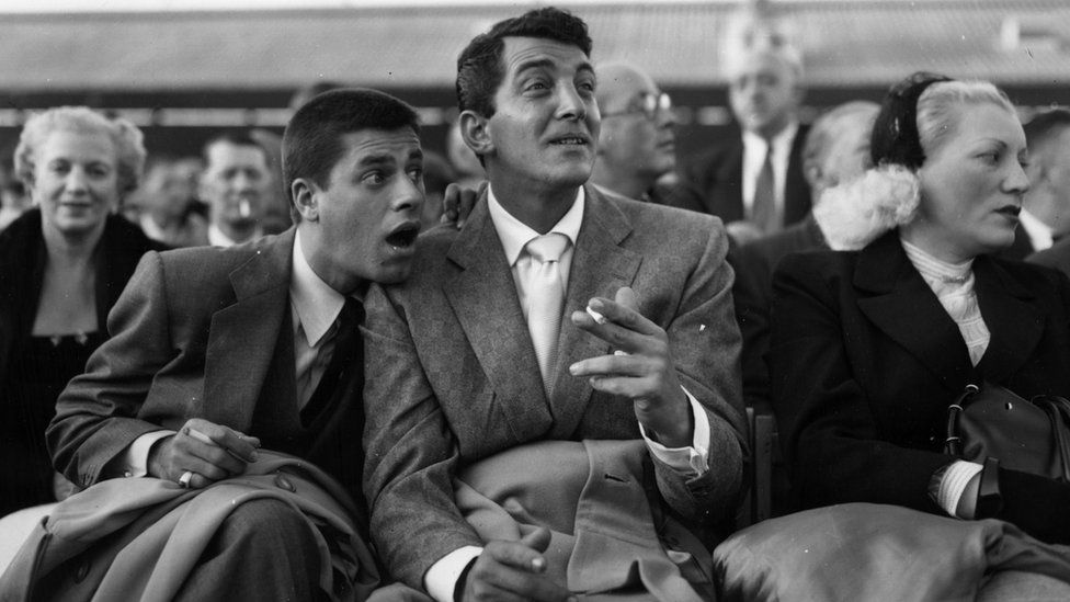 Dean Martin (born Dino Paul Crocetti 1917 - 1995), the Hollywood film star with Jerry Lewis at White City during the World Middleweight Championship of 1953